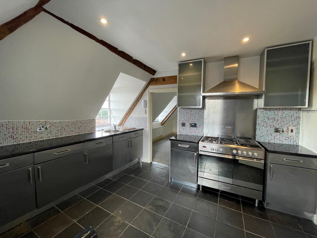 Lot: 90 - VACANT TOP FLOOR FLAT WITH VIEWS OVER SURROUNDING AREA - Kitchen with window to the rear and entrance to bedroom